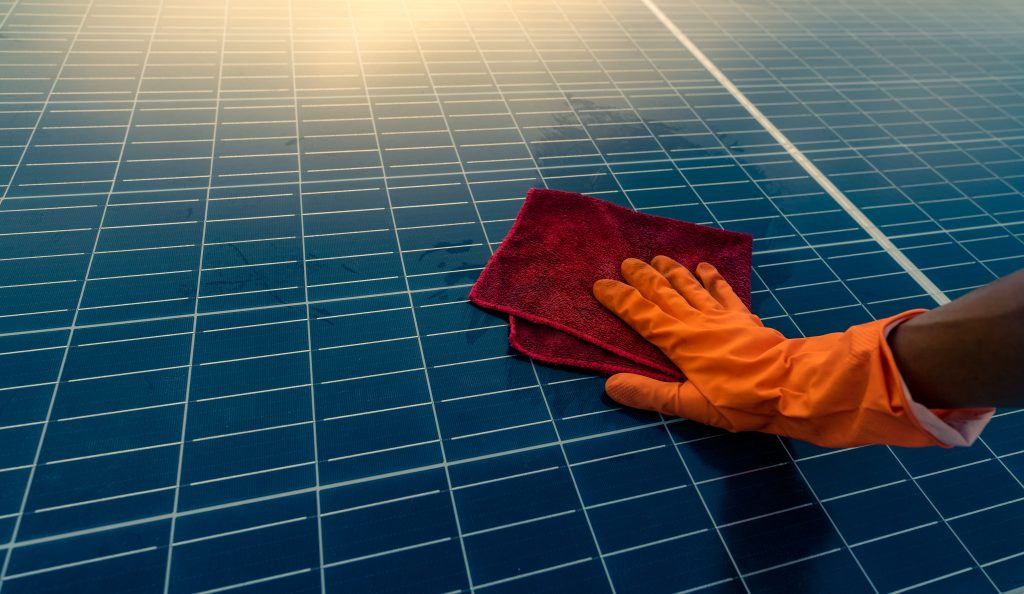 Man,Cleaning,Solar,Panel,On,Roof.,Solar,Panel,Or,Photovoltaic